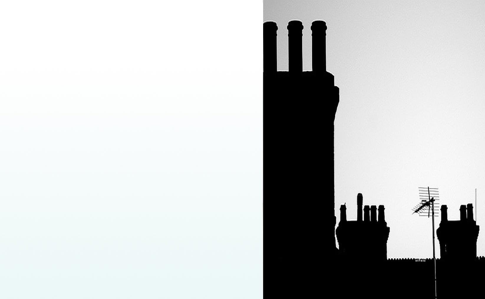 Silhouetted rows of traditional chimney stacks and pots against the sky